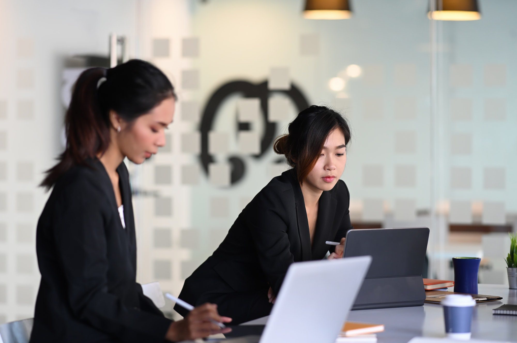 businesswoman-in-suit-experts-discussing-information-during-accounting-process-in-office-.jpg